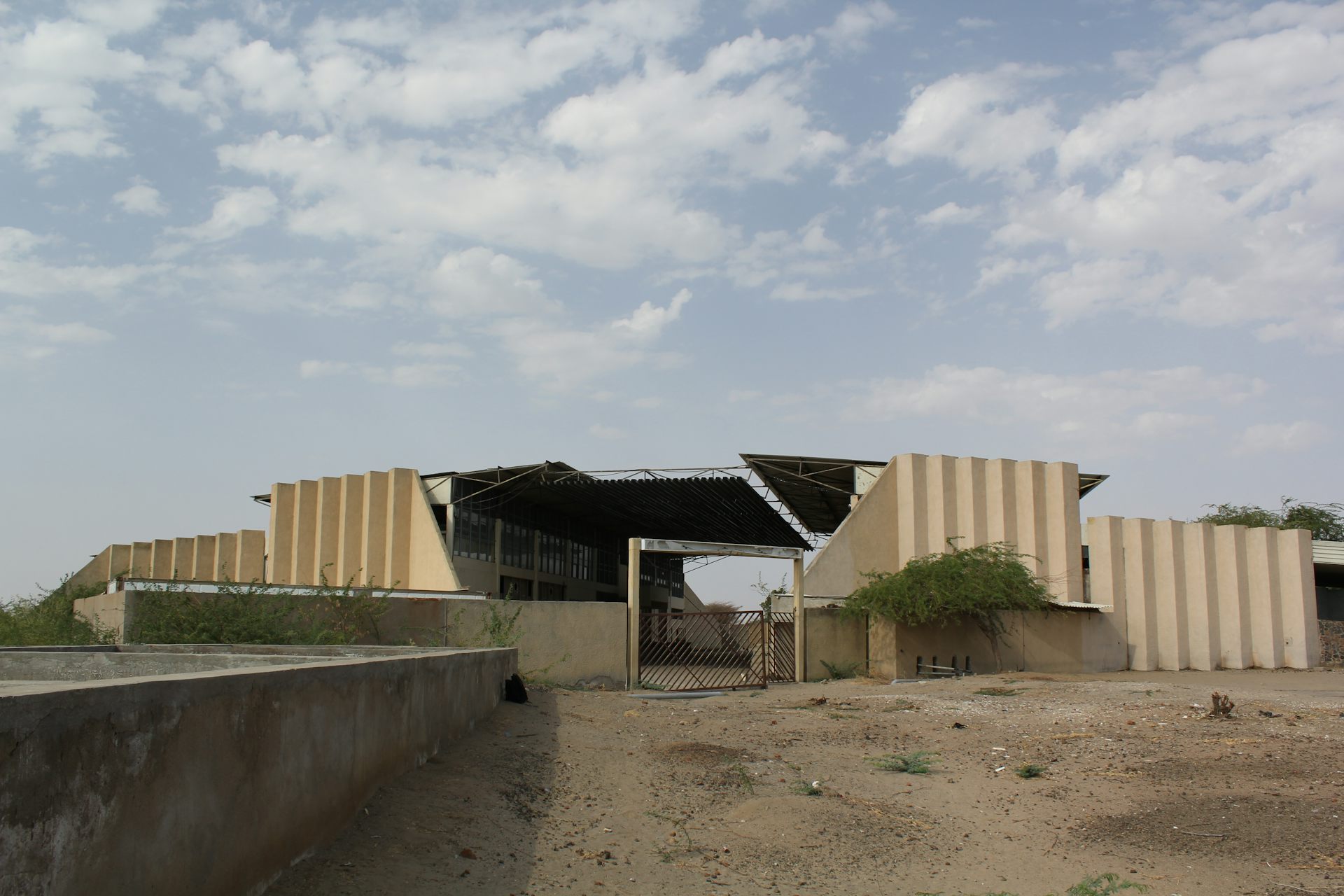 A deserted concrete and corrugated iron building