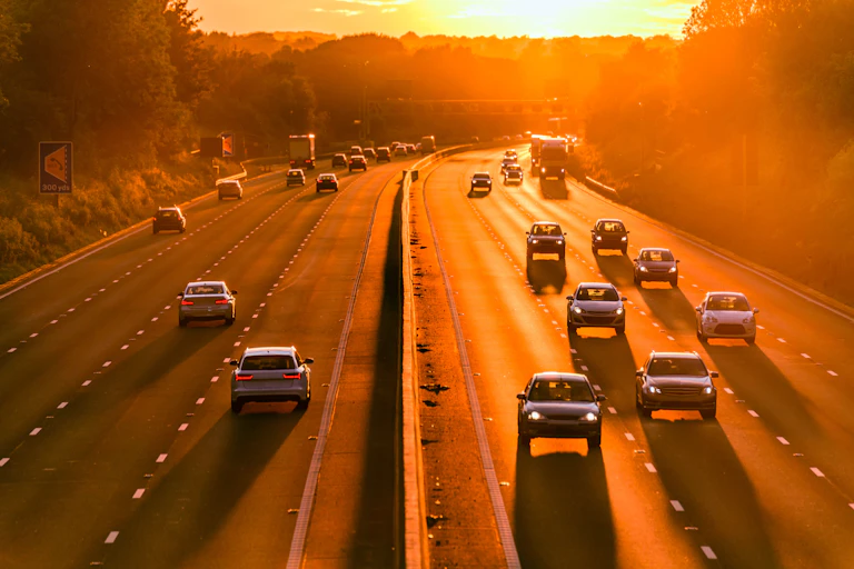 A motorway during hot weather at dusk.