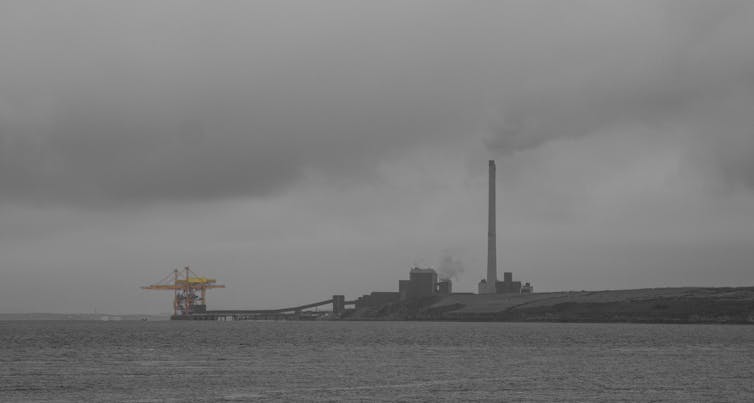 Power plant by the sea, grey skies.