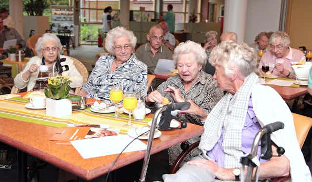 elderly people seated at table