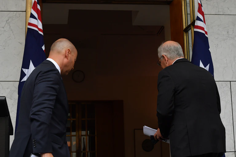 Australian Treasurer Josh Frydenberg and Prime Minister Scott Morrison leave after a press conference at Parliament House in Canberra, Wednesday January 19, 2022.