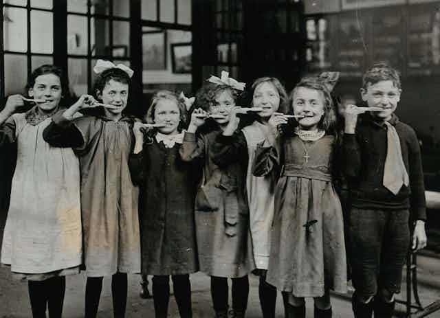 Pupils pose during a toothbrush drill at school in 1920.