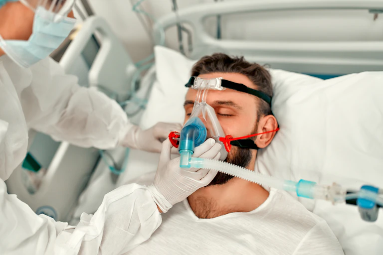 A COVID patient in hospital being given oxygen
