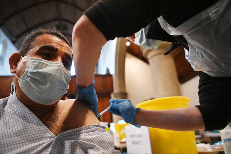 A man receiving a COVID booster