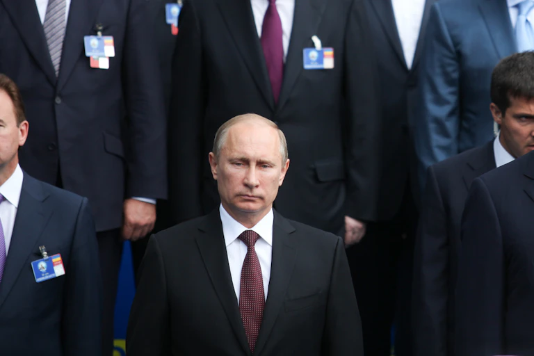 President Putin of Russia standing at a photocall.