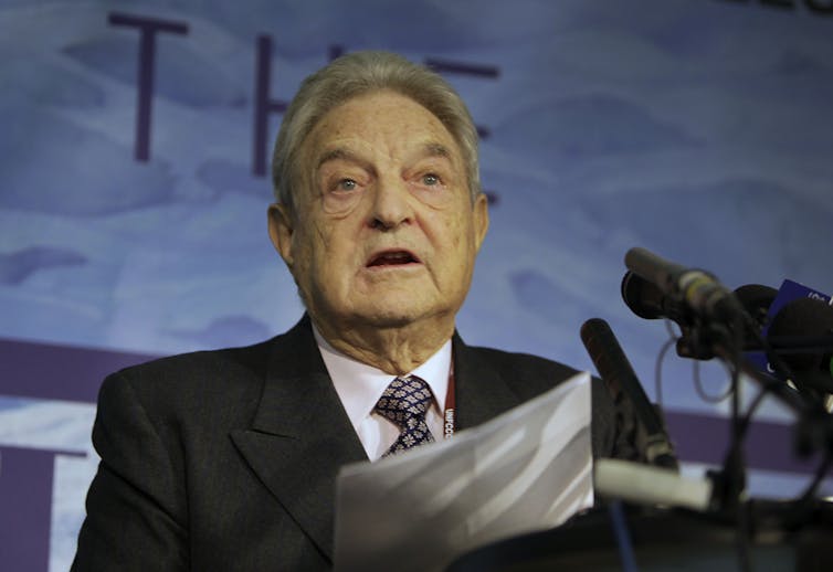 Billionaire George Soros speaking during a conference.