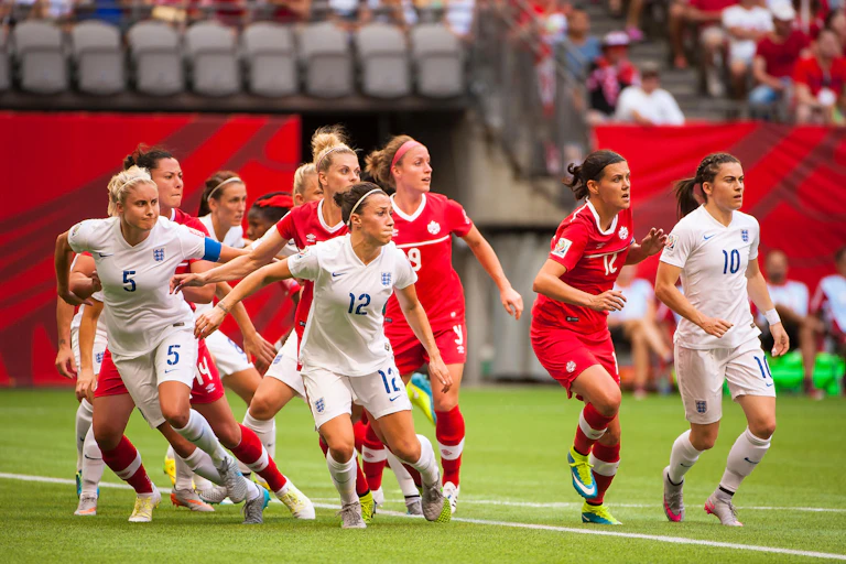 Canada and England players face the ball during a FIFA Women's World Cup Canada quarter-final in 2015.