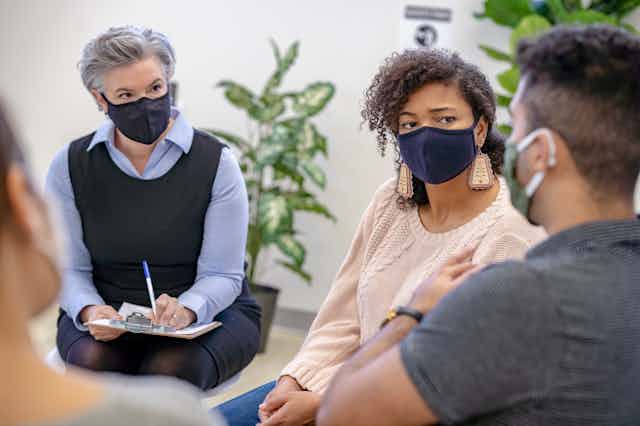 Students wear masks while attending a group therapy session.