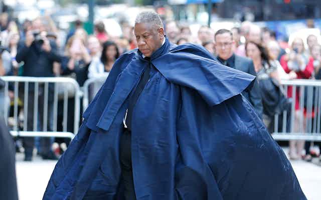 Andre Leon Talley in a large, blue cape