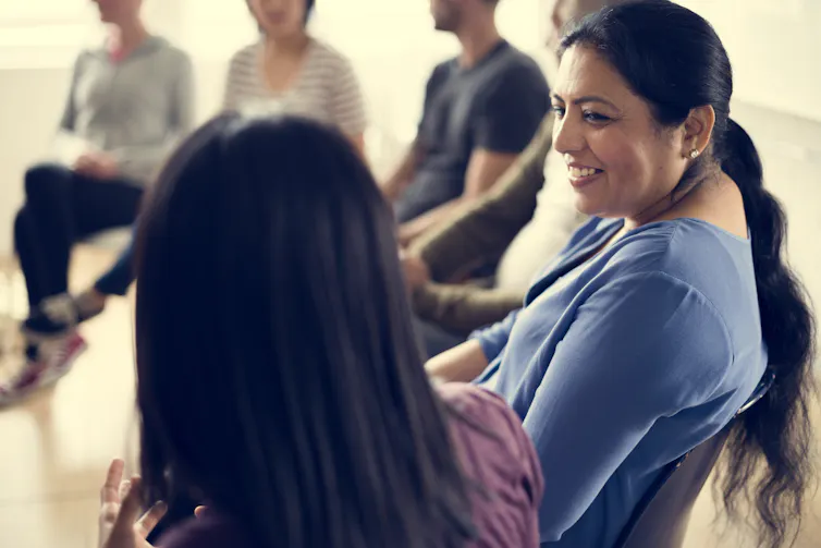 Women sitting in a meeting.