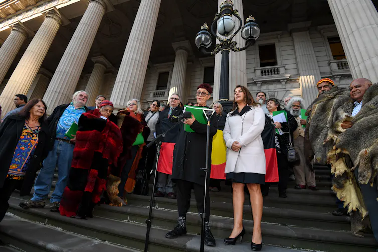 Aboriginal people, Elders and politicians outside Victorian Parliament House.