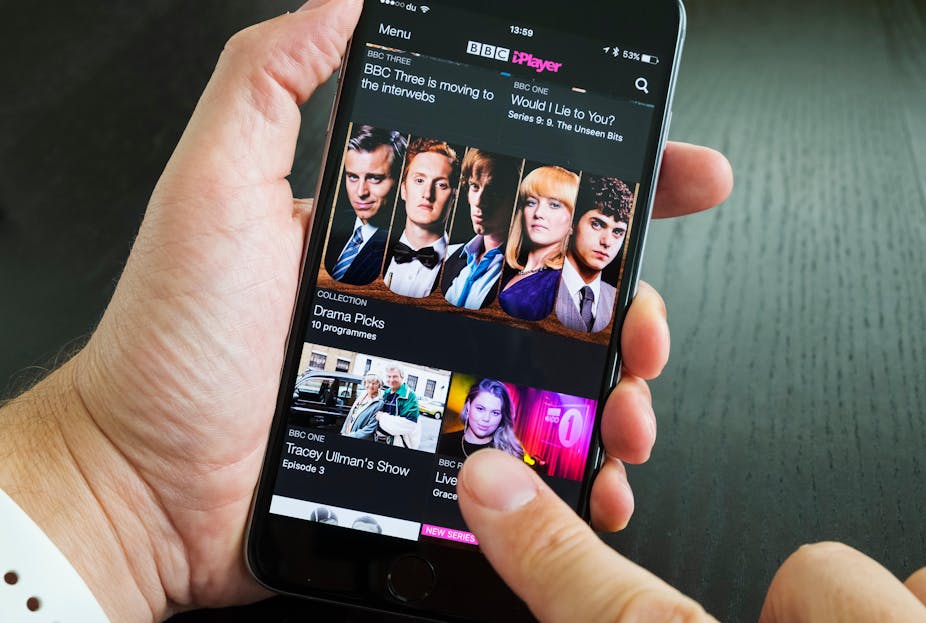 Person holding an iPhone with BBC iPlayer on it.
