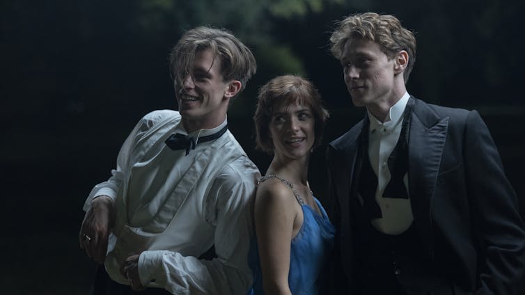 Two men in suits and a woman in a dress.