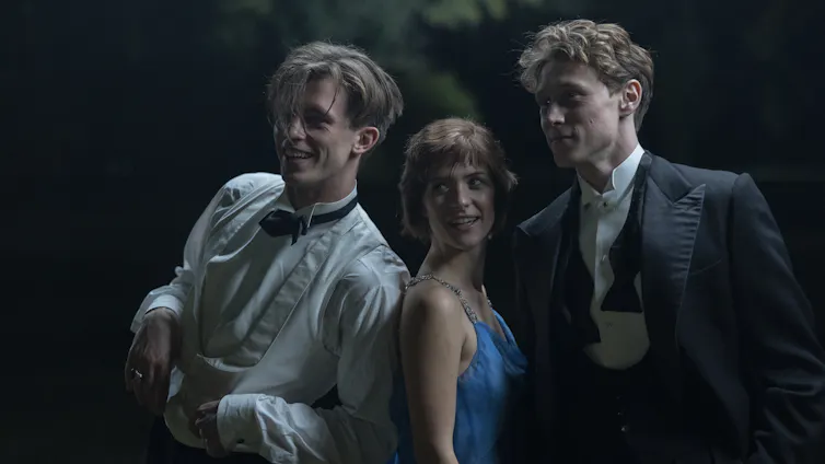 Two men in suits and a woman in a dress.