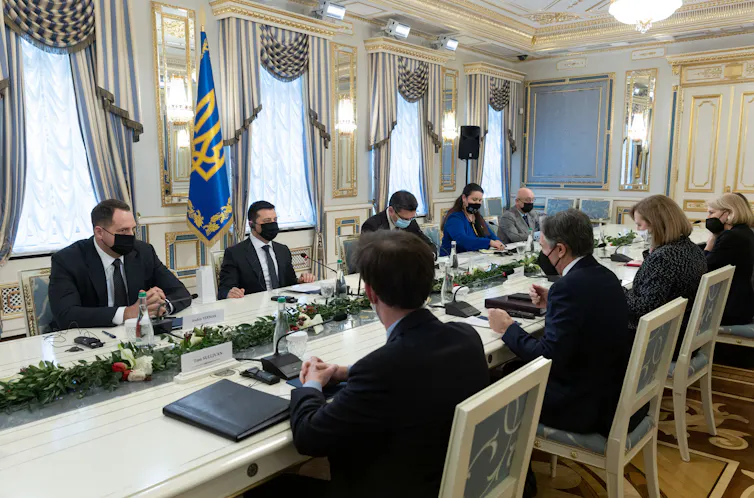 US and Ukrainian negotiators led by US secretary of state Antony Blinken and Ukranian president Volodymyr Zelensky sitting around a table in Kyiv, January 19 2022.