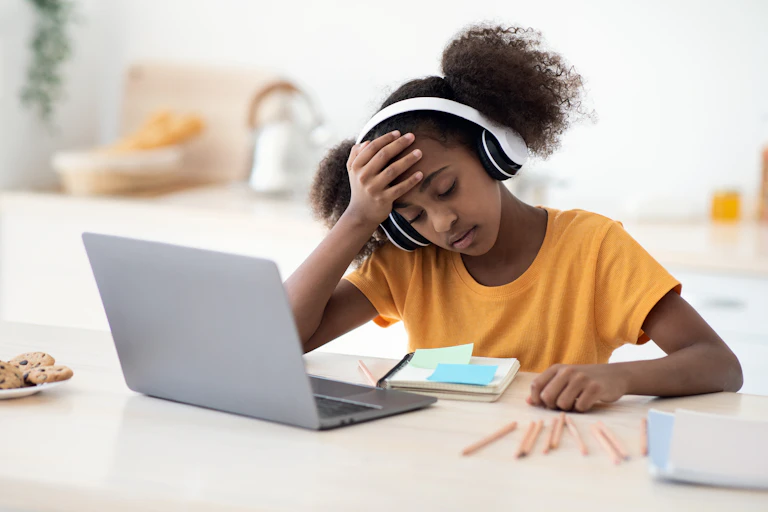 Girl looking worried at laptop