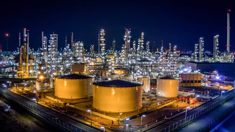 An oil refinery illuminated at night.