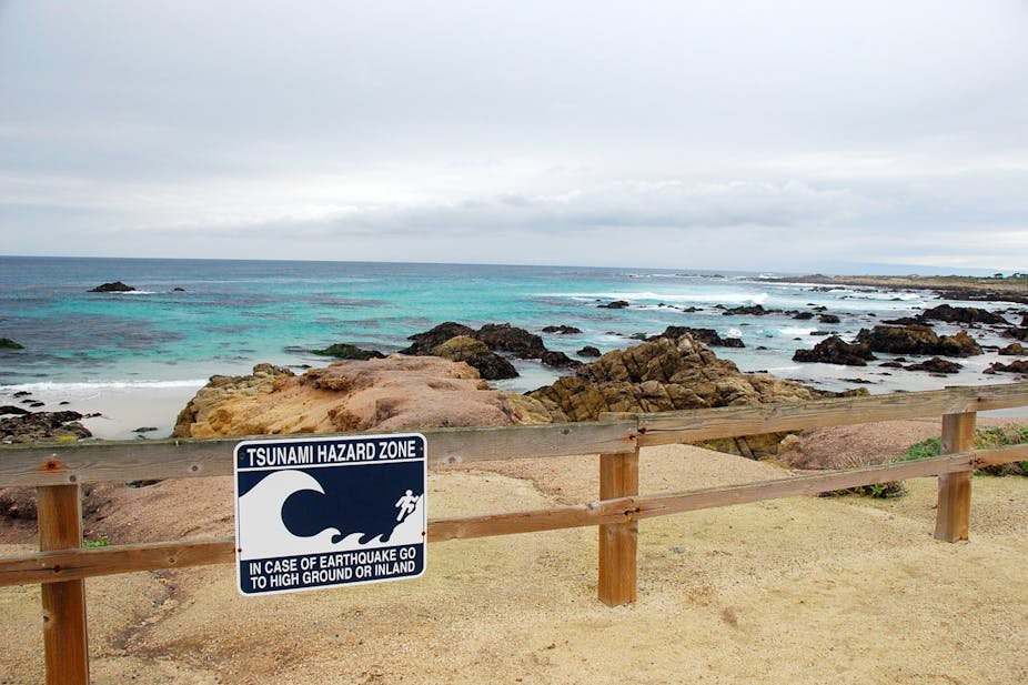 A 'tsunami hazard zone' sign along a coastline
