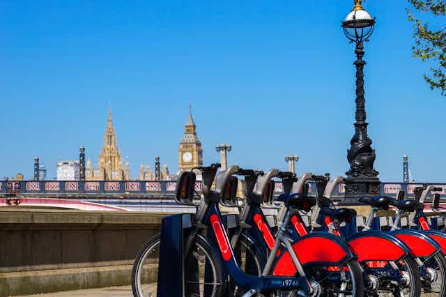 A row of rental bicycles with Big Ben in the background.