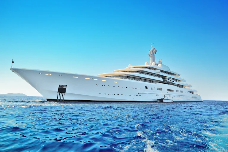 A super yacht on a calm blue sea.