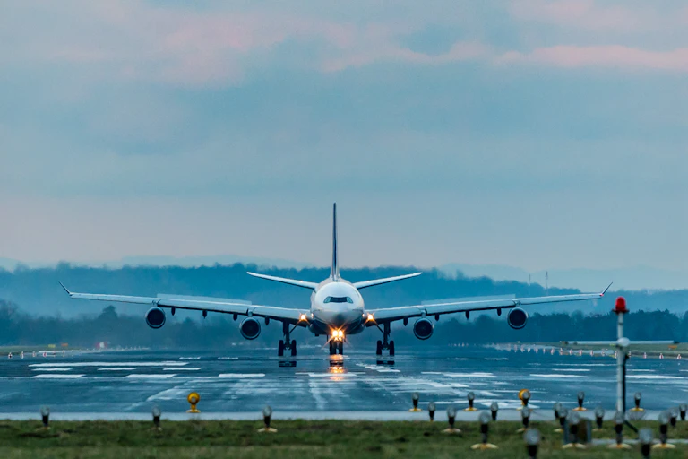 A plane lands on a runway.