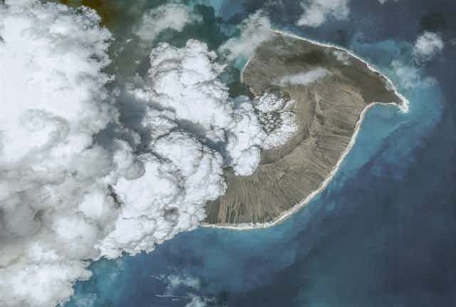 An aerial view of the volcano with steam rising