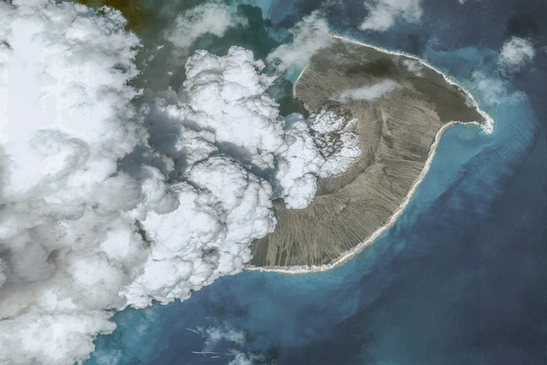 An aerial view of the volcano with steam rising