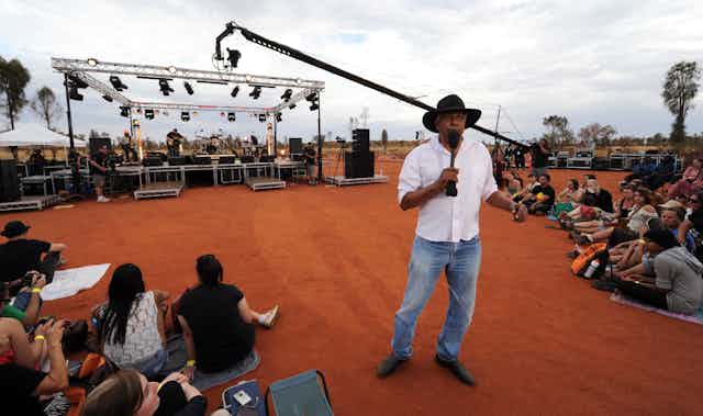 Ernie Dingo presenting on the National Indigenous Television channel from Uluru, 2012.