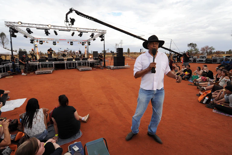 Ernie Dingo presenting on the National Indigenous Television channel from Uluru, 2012.