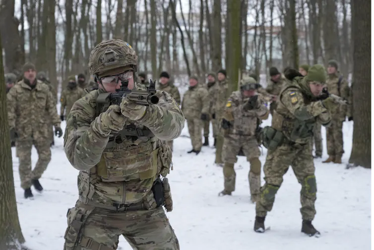 People in combat gear carrying weapons in a snowy park.
