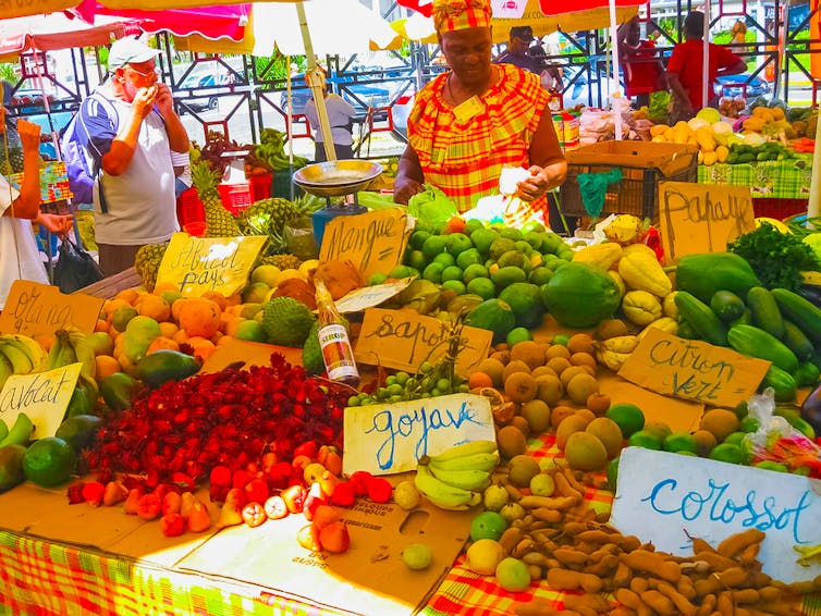 Une femme dans un marché de fruits et de légumes