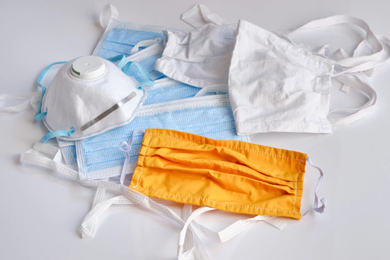A pile of surgical, cloth and N95 masks.