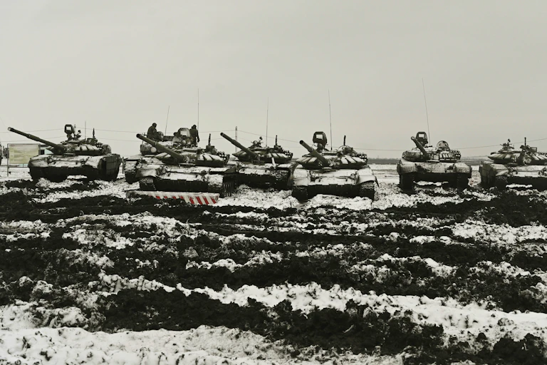 A row of tanks in a snowy field