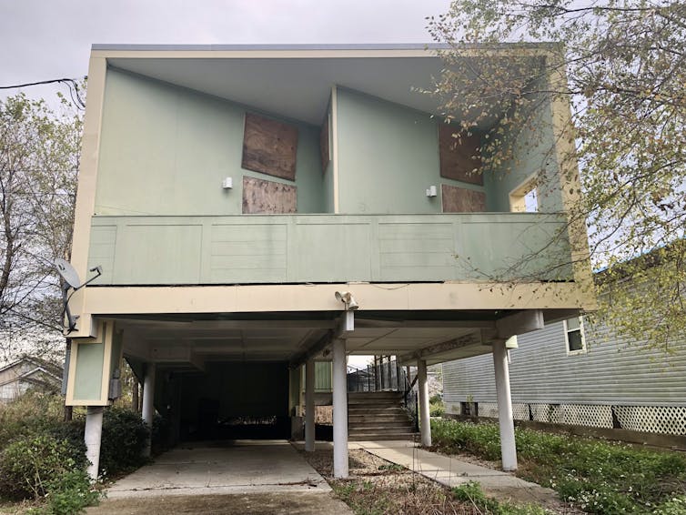 A boarded-up house on stilts in New Orleans