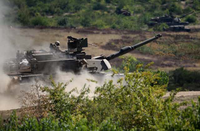 US tanks kick up dust as they roll through Poland.