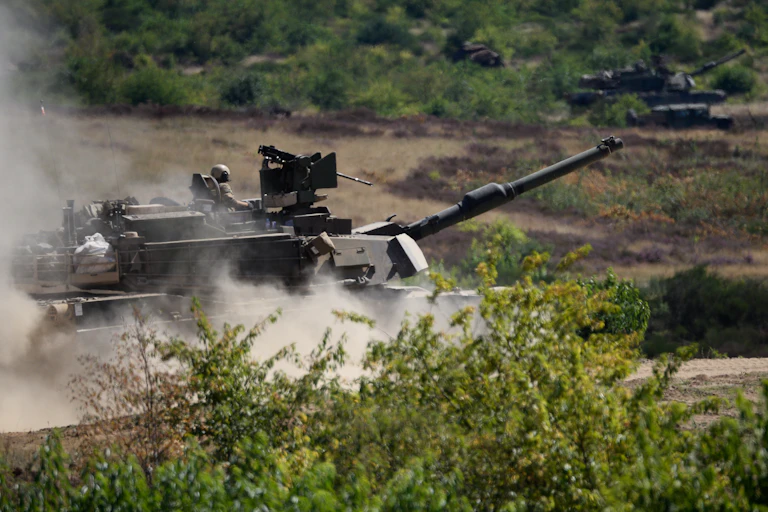 US tanks kick up dust as they roll through Poland.