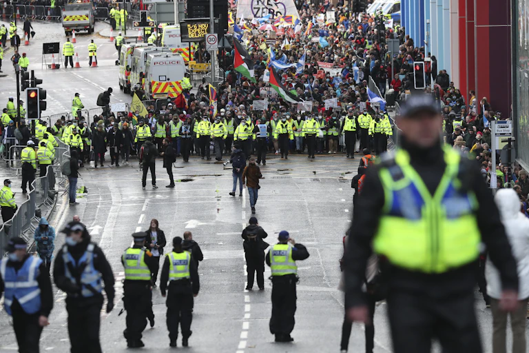 Police officers accompany climate activists during protest march.