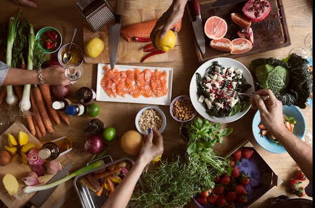 A table filled with seafood, vegetables and fruits.