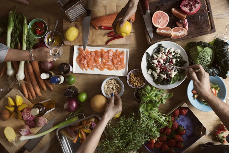 A table filled with seafood, vegetables and fruits.