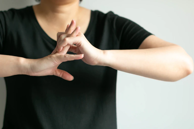 Woman cracking her knuckles