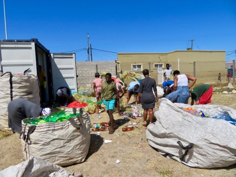 Volunteers from Eluvukweni Anglican Church in Crossroads in Cape Town, sorting and storing plastic bottles collected by the congregation.