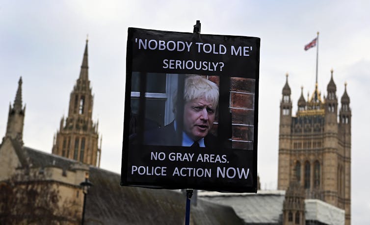 Placard at partygate protest reads'Nobody told me' Seriously? No grey areas. Police action NOW'