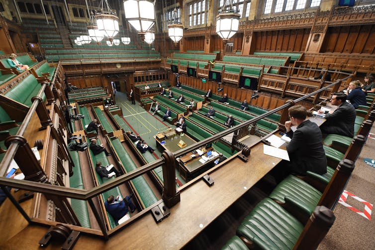 The inside of House of Commons from above, with socially-distanced MPs seated on the benches.