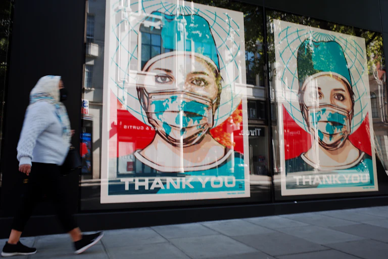 posters of masked health care workers in store window