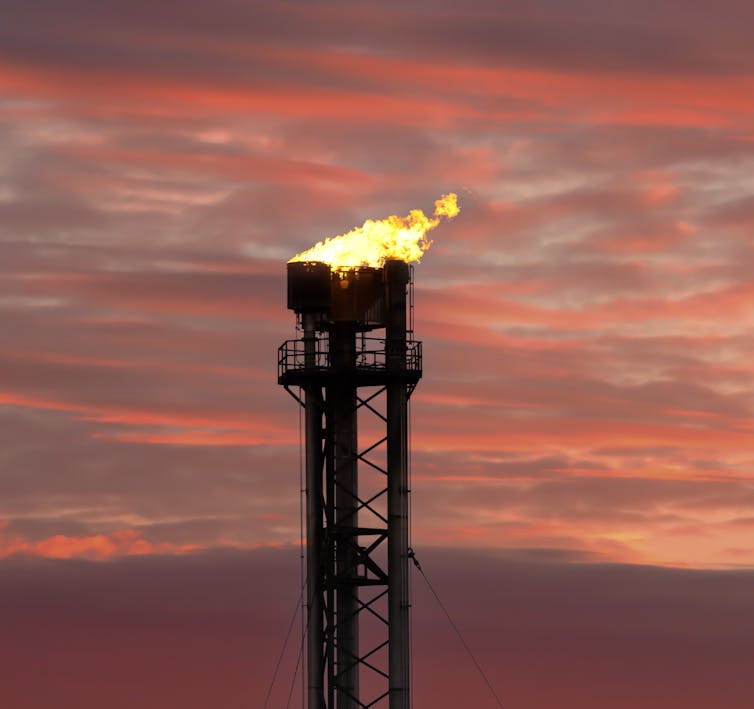 A gas flare atop a metal structure.