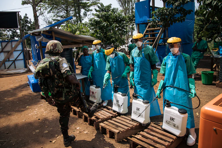 people in hazmat suits lined up