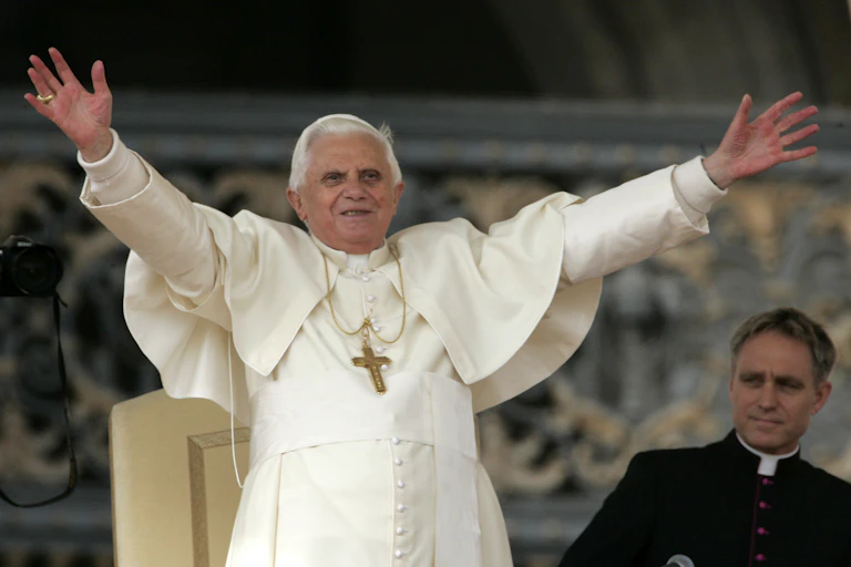 Pope Benedict XVI waves to a crowd.
