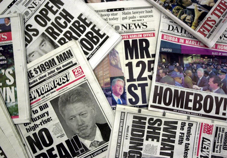 Stacks of newspapers featuring Bill Clinton.