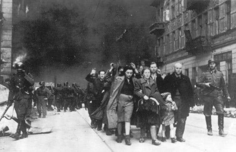 Polish Jews led away for deportation by German SS soldiers.