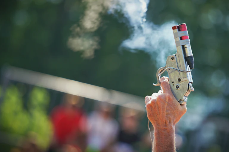 A starter pistol being fired.